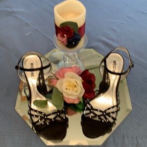 Shoes are black leather with rhinestones.